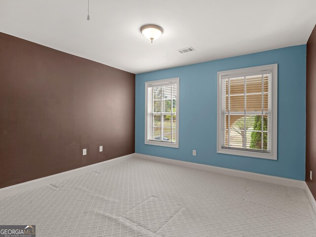 5297 Heron Bay Blvd, Locust Grove, GA 30248 - spare room featuring carpet flooring, baseboards, and visible vents