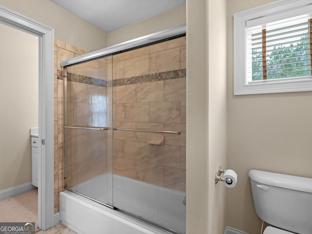 5297 Heron Bay Blvd, Locust Grove, GA 30248 - full bathroom with toilet, enclosed tub / shower combo, and baseboards