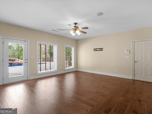 5297 Heron Bay Blvd, Locust Grove, GA 30248 - unfurnished living room featuring dark wood-style floors, baseboards, visible vents, and a ceiling fan