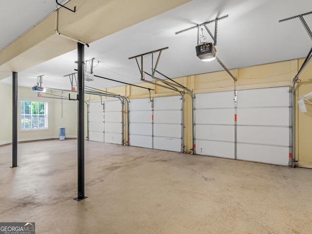 5297 Heron Bay Blvd, Locust Grove, GA 30248 - garage featuring baseboards and a garage door opener