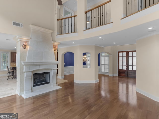 5297 Heron Bay Blvd, Locust Grove, GA 30248 - unfurnished living room featuring ornamental molding, visible vents, baseboards, and wood finished floors