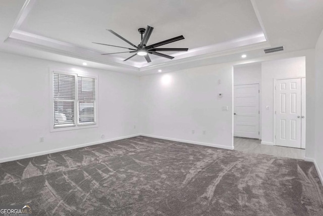 4066 Wild Orchid Ln, Loganville, GA 30052 - unfurnished room featuring carpet flooring, visible vents, a tray ceiling, and a ceiling fan