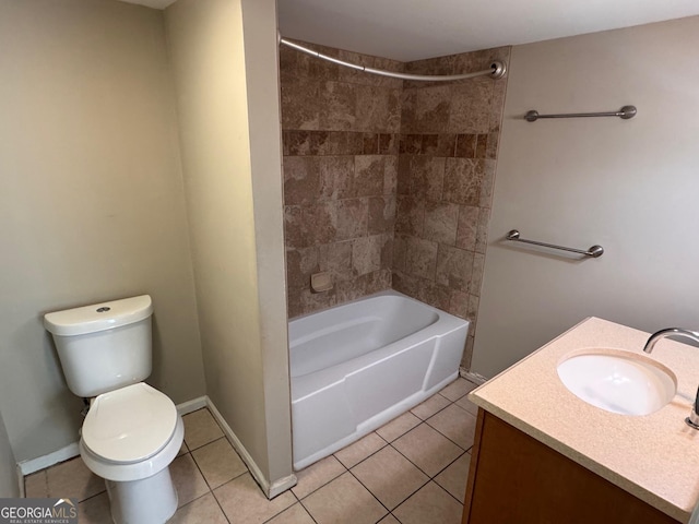 bathroom featuring tile patterned floors, toilet, vanity, baseboards, and  shower combination