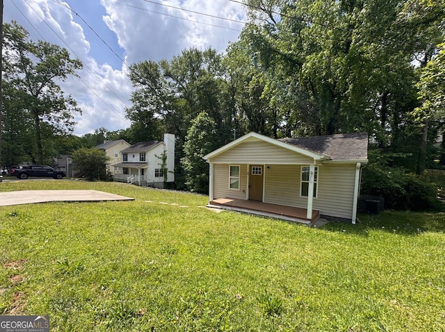 bungalow-style home with covered porch and a front yard