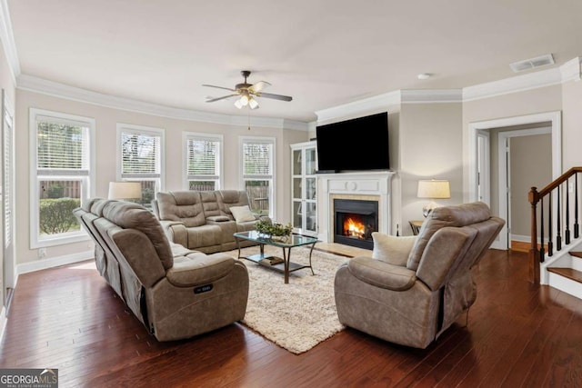 living area featuring dark wood-type flooring, visible vents, baseboards, and ceiling fan