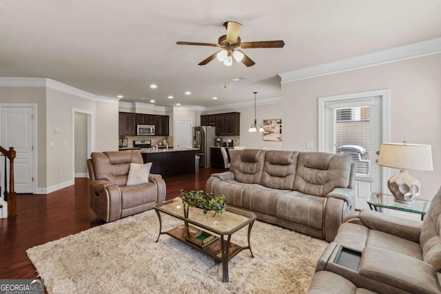 living area with baseboards, a ceiling fan, dark wood-style floors, crown molding, and recessed lighting