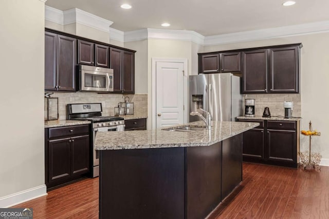 kitchen featuring baseboards, a sink, appliances with stainless steel finishes, dark brown cabinets, and dark wood-type flooring
