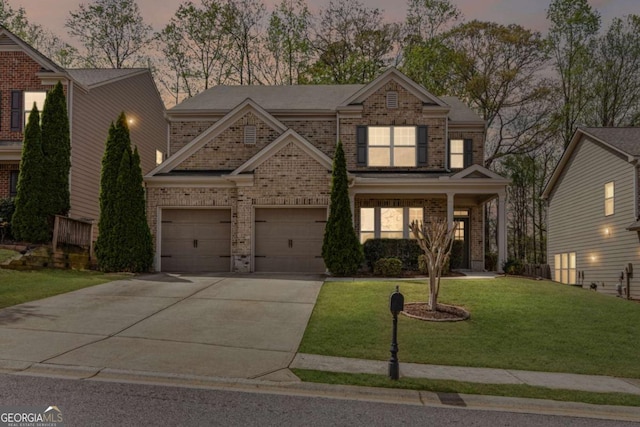 view of front of property featuring brick siding, a front lawn, and driveway