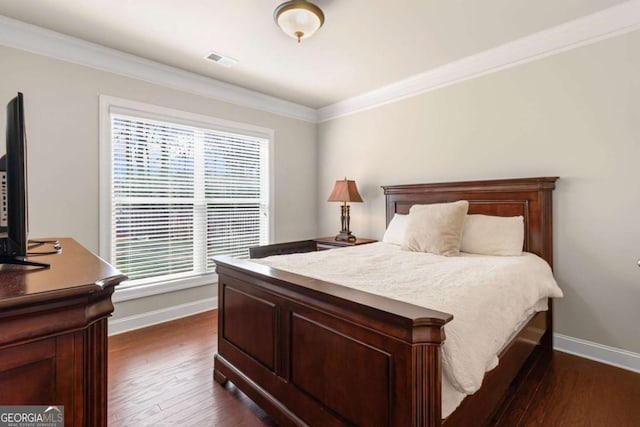 bedroom with baseboards, visible vents, dark wood-style flooring, and crown molding