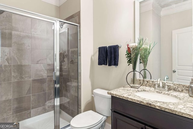 full bath featuring toilet, a stall shower, vanity, and crown molding