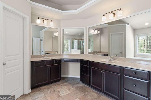 full bath with a sink, two vanities, recessed lighting, and a stall shower