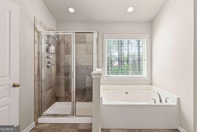 full bathroom featuring a bath, a stall shower, baseboards, and recessed lighting