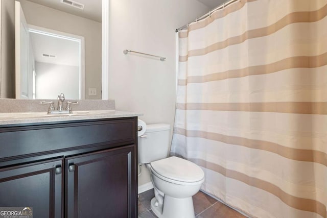 bathroom featuring visible vents, toilet, vanity, and tile patterned floors