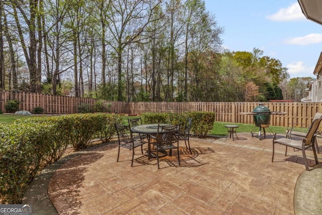 view of patio featuring a fenced backyard, outdoor dining area, and area for grilling