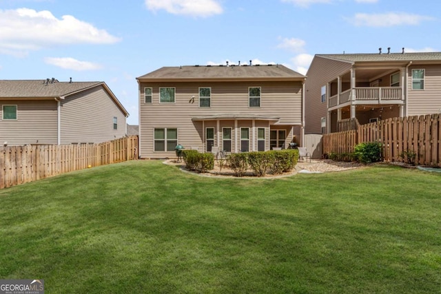 back of property featuring a yard and a fenced backyard