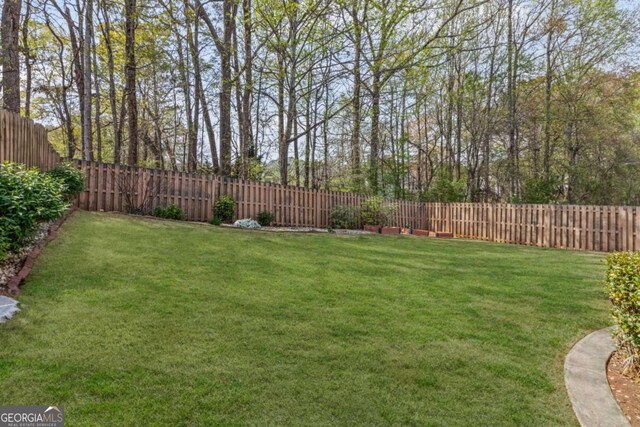 view of yard with a fenced backyard