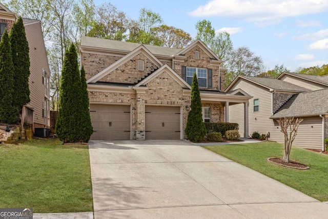 craftsman-style home with brick siding, a front lawn, central AC unit, and driveway