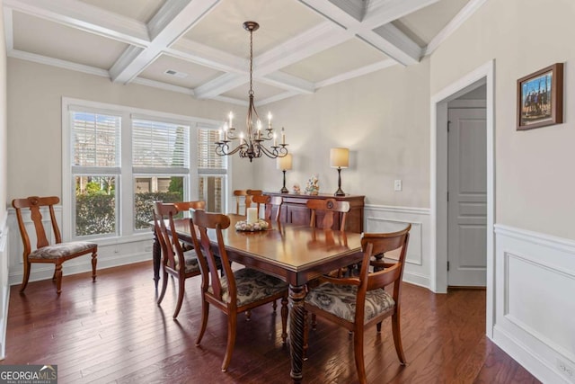 dining area with beam ceiling, an inviting chandelier, and dark wood finished floors