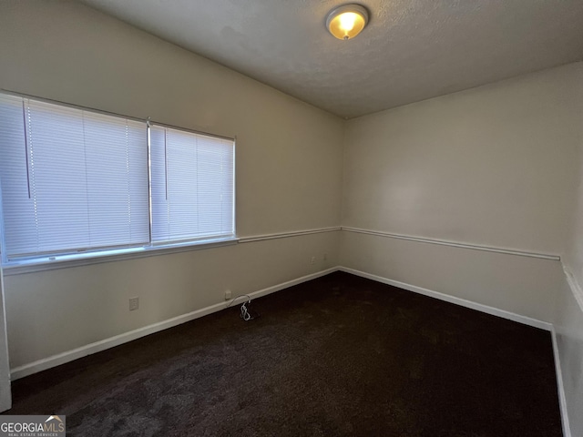7560 Taylor Rd # 5, Riverdale, GA 30274 - unfurnished room with dark carpet and baseboards