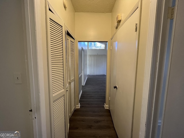 7560 Taylor Rd # 5, Riverdale, GA 30274 - hallway with a textured ceiling and dark wood-style flooring