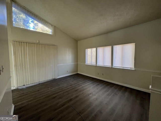 7560 Taylor Rd # 5, Riverdale, GA 30274 - spare room featuring plenty of natural light, dark wood-style flooring, baseboards, and lofted ceiling