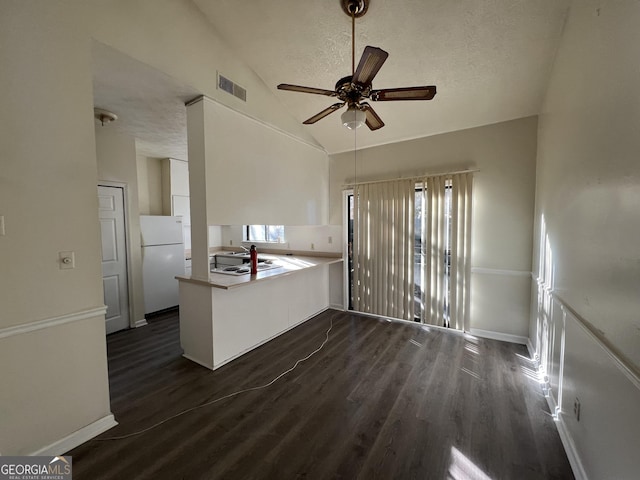 7560 Taylor Rd # 5, Riverdale, GA 30274 - kitchen featuring visible vents, dark wood-style flooring, ceiling fan, freestanding refrigerator, and lofted ceiling