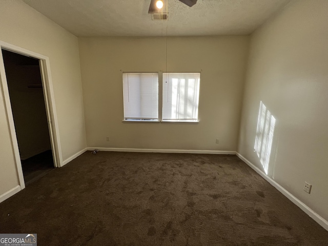 7560 Taylor Rd # 5, Riverdale, GA 30274 - unfurnished room featuring dark colored carpet, baseboards, a textured ceiling, a ceiling fan, and visible vents