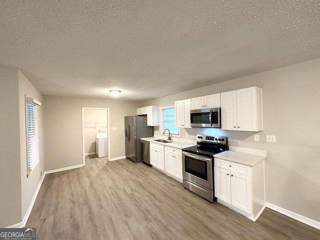 2942 Elkhorn Ct, Decatur, GA 30034 - kitchen featuring a sink, washer / clothes dryer, light countertops, and appliances with stainless steel finishes