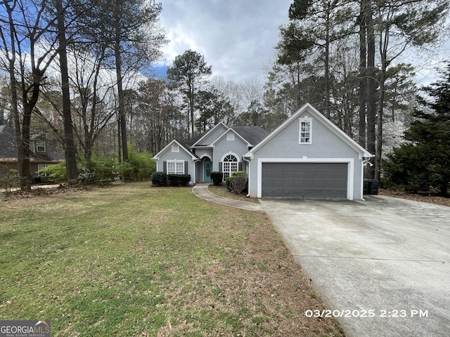 135 Flowers Dr, Covington, GA 30016 - traditional home featuring concrete driveway, stucco siding, a garage, and a front yard