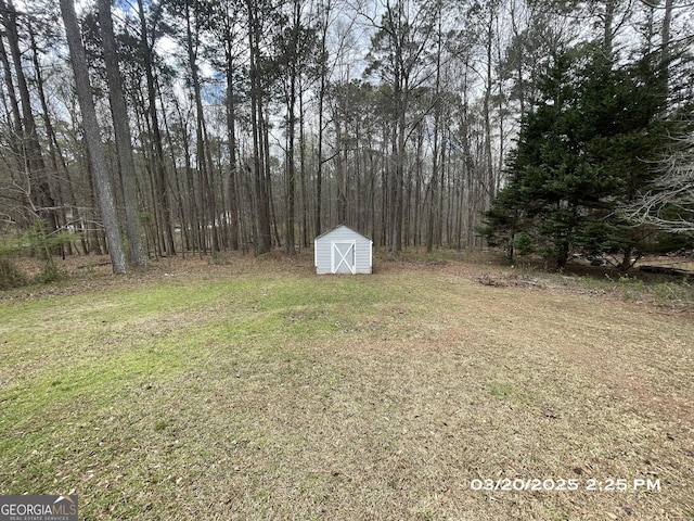 135 Flowers Dr, Covington, GA 30016 - view of yard with a storage shed and an outbuilding