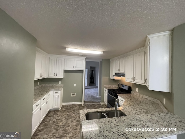 135 Flowers Dr, Covington, GA 30016 - kitchen with white cabinets, a sink, stainless steel gas range, light stone countertops, and extractor fan