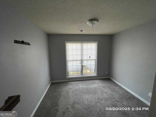 135 Flowers Dr, Covington, GA 30016 - unfurnished room with visible vents, baseboards, carpet, and a textured ceiling