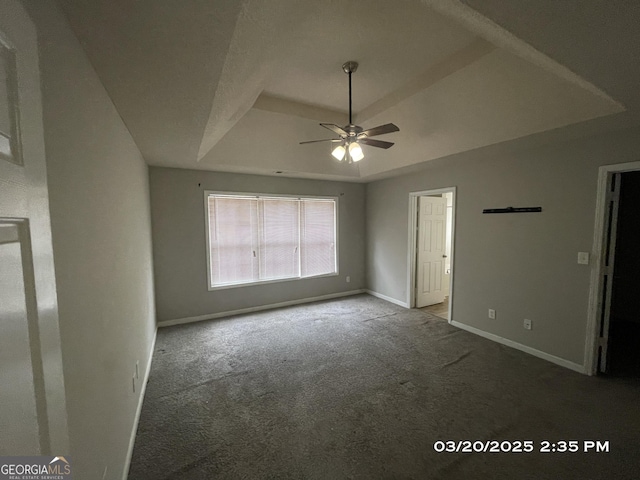 135 Flowers Dr, Covington, GA 30016 - unfurnished bedroom featuring a tray ceiling, baseboards, a ceiling fan, and carpet floors