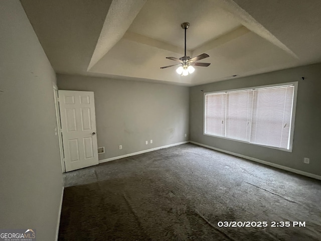 135 Flowers Dr, Covington, GA 30016 - carpeted spare room featuring a tray ceiling, ceiling fan, and baseboards