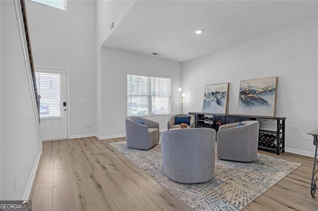 living area with wood finished floors, visible vents, and plenty of natural light