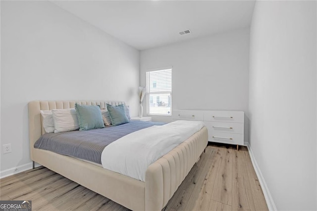 bathroom with wood finished floors, vanity, baseboards, toilet, and an enclosed shower