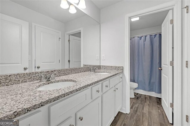 home office featuring baseboards, wood finished floors, visible vents, and recessed lighting