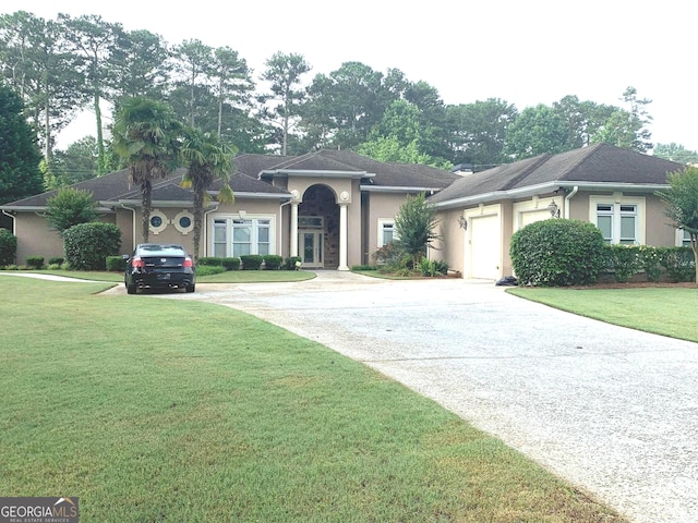 6279 Giles Rd, Lithonia, GA 30058 - ranch-style house with driveway, stucco siding, a front lawn, and an attached garage