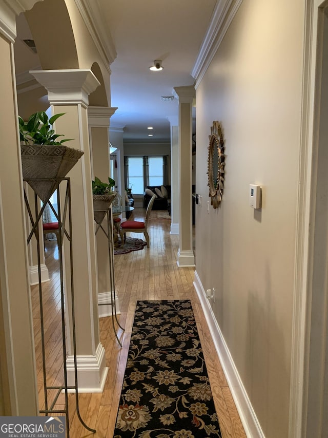 6279 Giles Rd, Lithonia, GA 30058 - hall with decorative columns, light wood-style floors, and crown molding