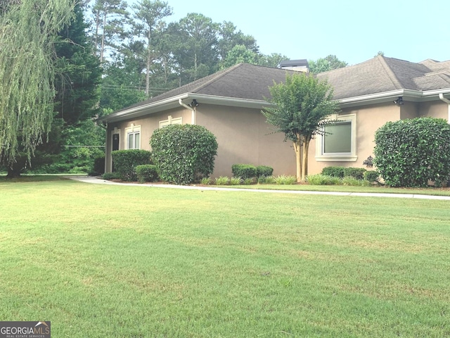 6279 Giles Rd, Lithonia, GA 30058 - view of property exterior with stucco siding and a yard
