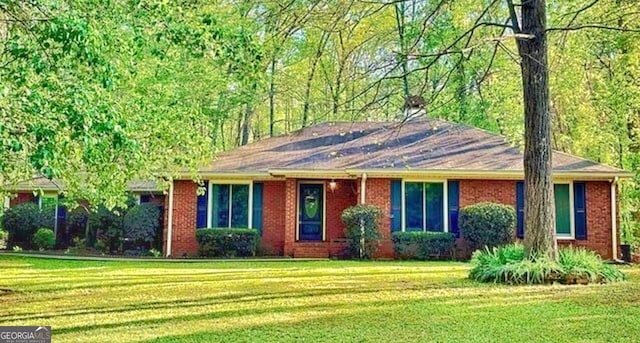 ranch-style house with brick siding and a front lawn