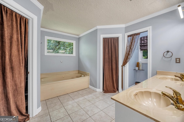 bathroom with tile patterned flooring, a sink, a textured ceiling, and a bath