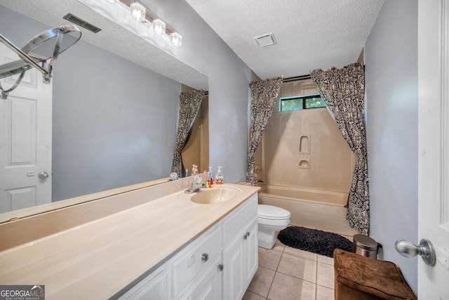 bathroom featuring a textured ceiling, visible vents, tile patterned floors, vanity, and toilet