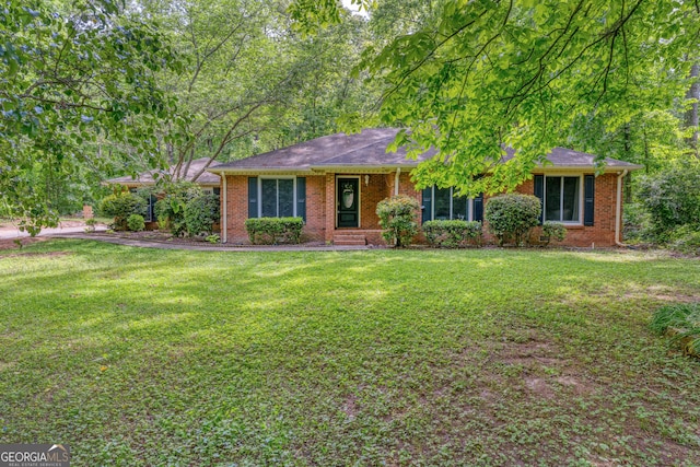 ranch-style house with brick siding and a front yard