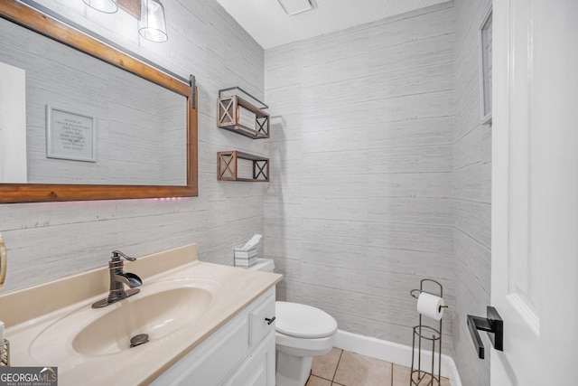 bathroom with tile patterned floors, vanity, and toilet