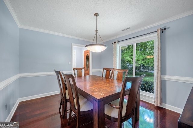 dining space with visible vents, crown molding, wood finished floors, baseboards, and a textured ceiling