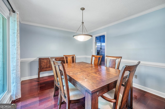 dining area with a textured ceiling, baseboards, ornamental molding, and wood finished floors