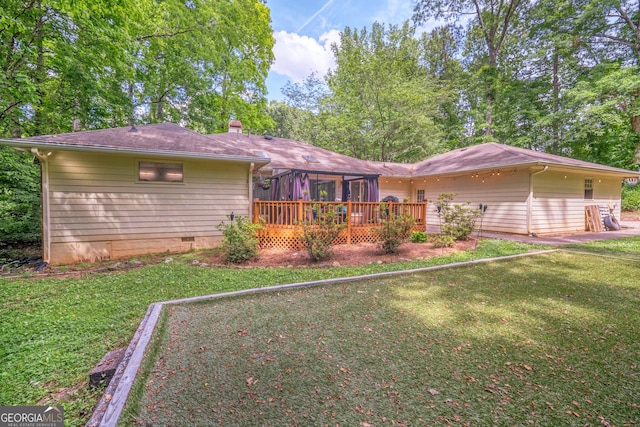 single story home featuring crawl space, a wooden deck, a front yard, and a chimney