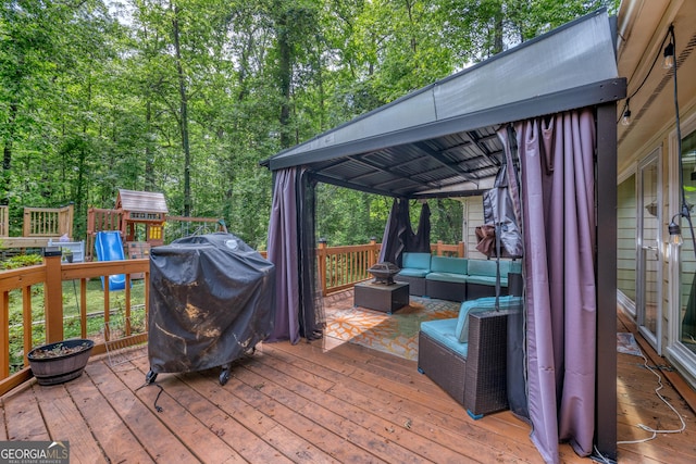 deck featuring outdoor lounge area, a playground, and a grill