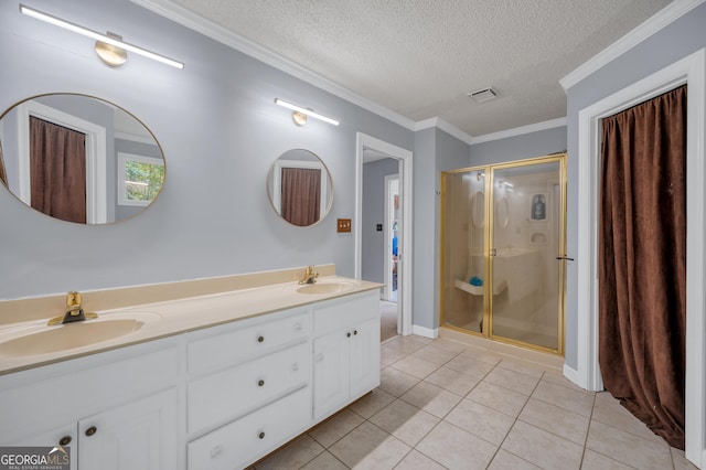 bathroom featuring a sink, a textured ceiling, tile patterned floors, and a stall shower